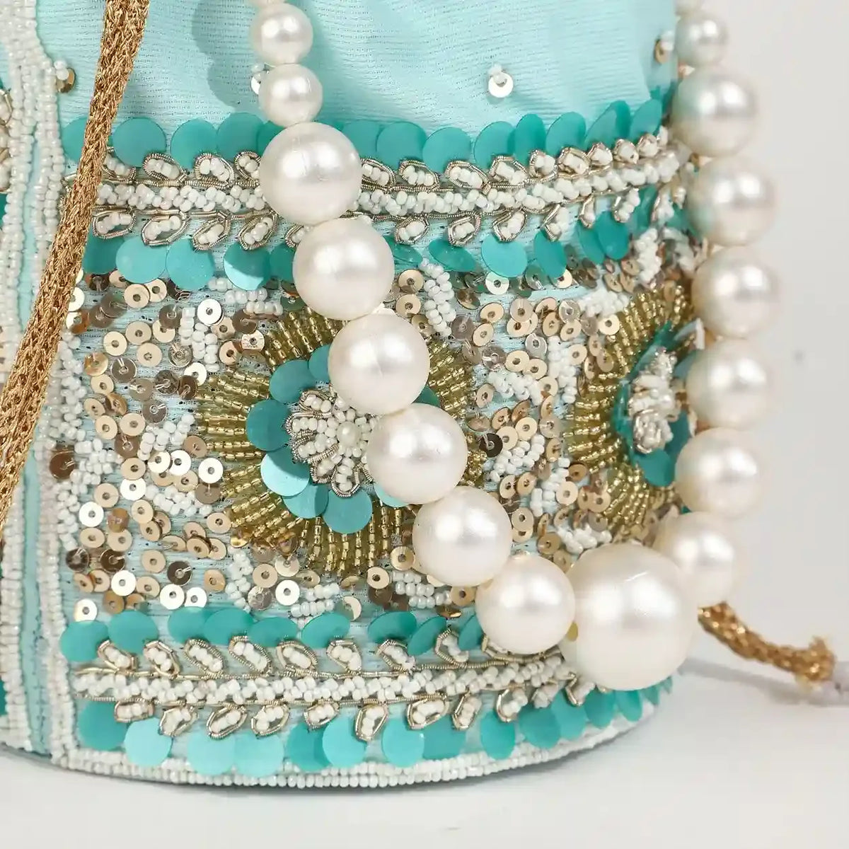 Ama Potli bag with pearl handle by The Tan Clan, featuring intricate embroidery and elegant pearl accents.