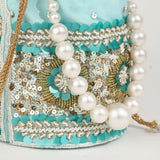 Ama Potli bag with pearl handle by The Tan Clan, featuring intricate embroidery and elegant pearl accents.