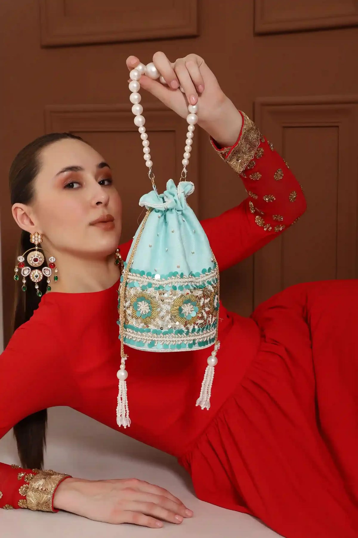 Ama Potli Bag by The Tan Clan with elegant pearl handle, featuring traditional embroidery and compact design for special occasions.