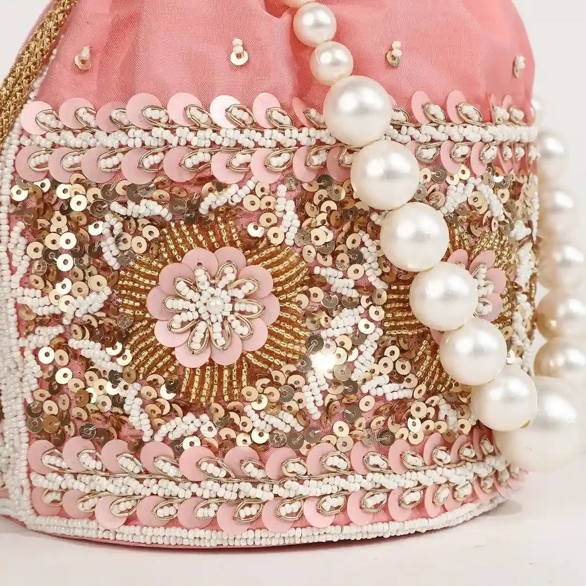 Ama Potli Bag by The Tan Clan with elegant pearl handle, featuring traditional design and intricate embroidery.