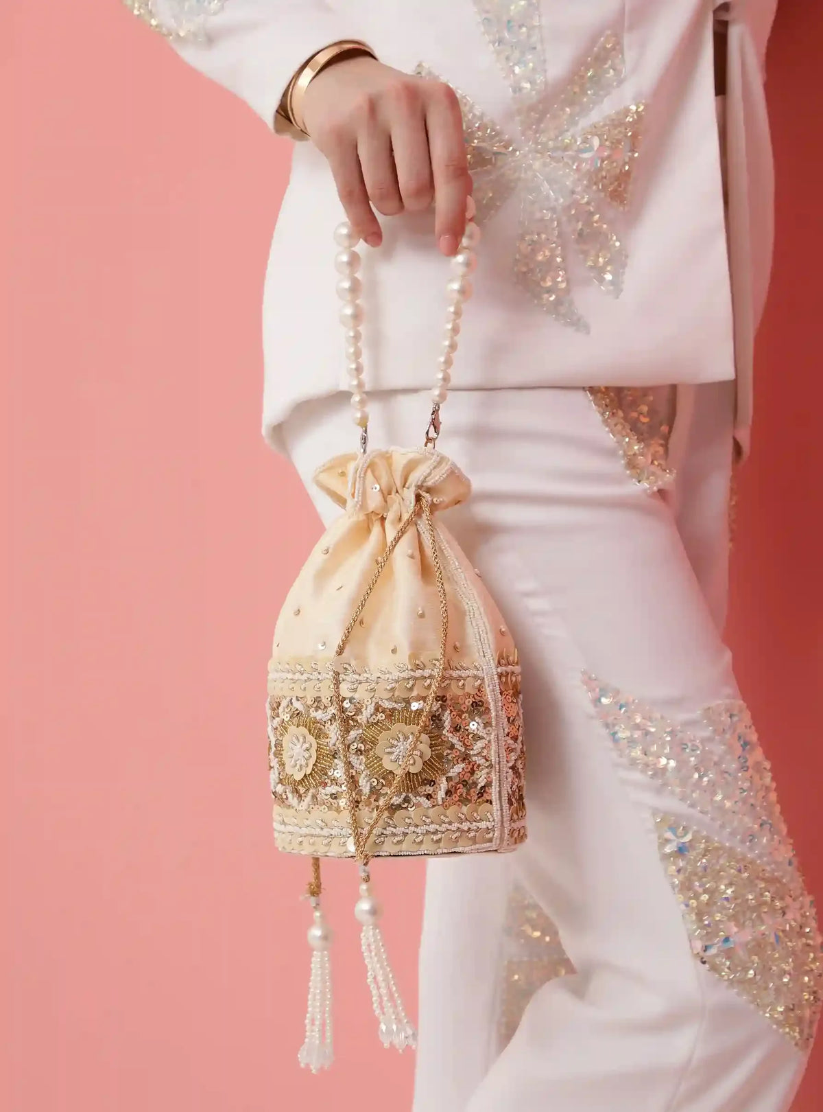 Ama Potli Bag by The Tan Clan featuring a pearl handle and traditional design, perfect for elegant occasions.