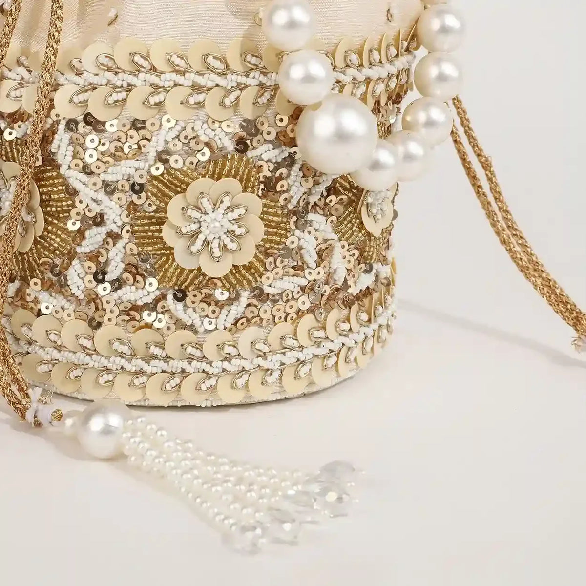 Ama potli bag with pearl handle from The Tan Clan, featuring intricate design and elegant pearl accents for traditional occasions.