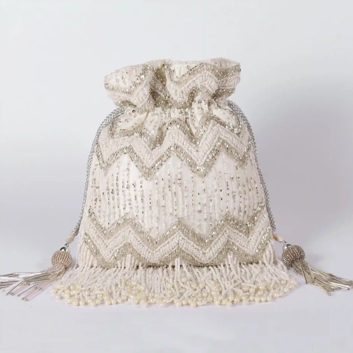 Amaal Potli Bag with Handle by The Tan Clan featuring intricate embroidery and a traditional design.