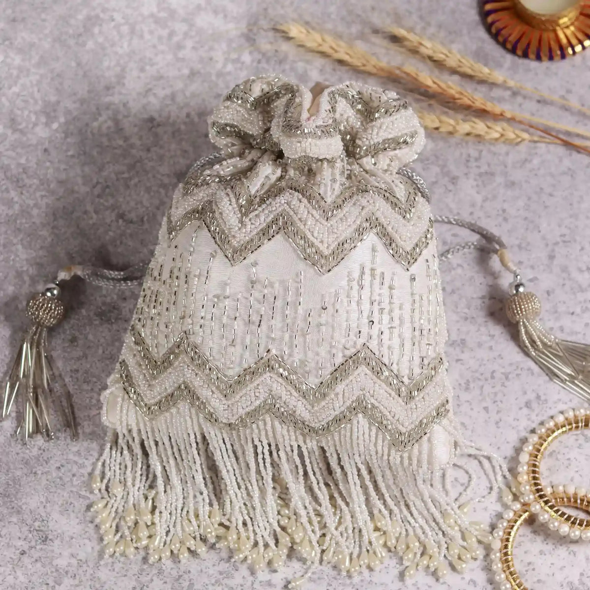 Amaal Potli Bag with Handle from The Tan Clan, featuring intricate embroidery and a stylish design for traditional or casual wear.