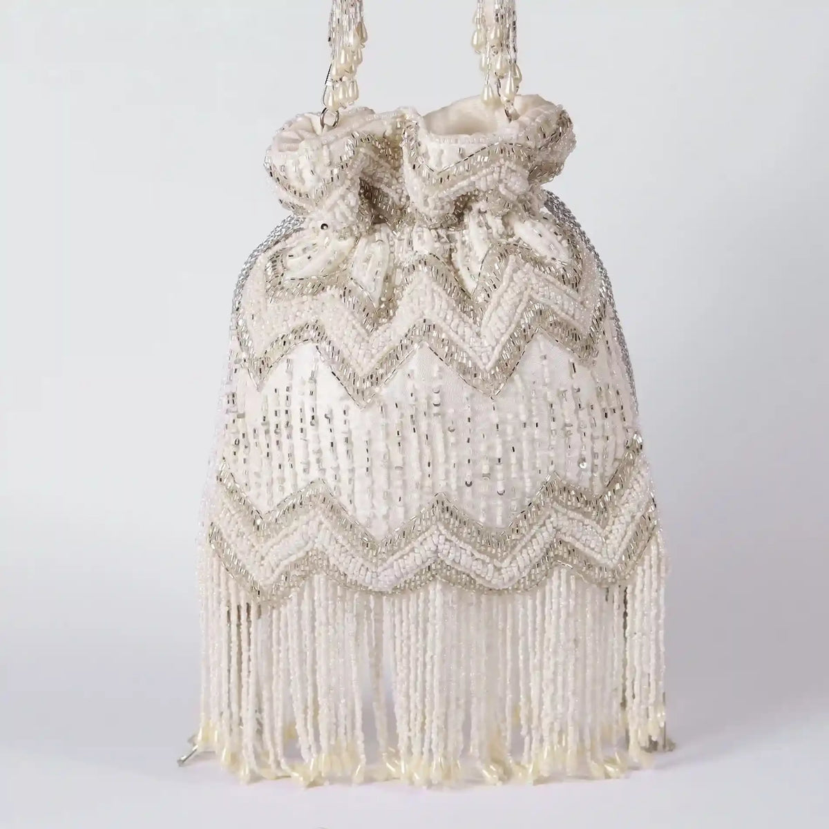 Amaal Potli bag with handle from The Tan Clan, featuring intricate embroidery and traditional design for festive occasions.