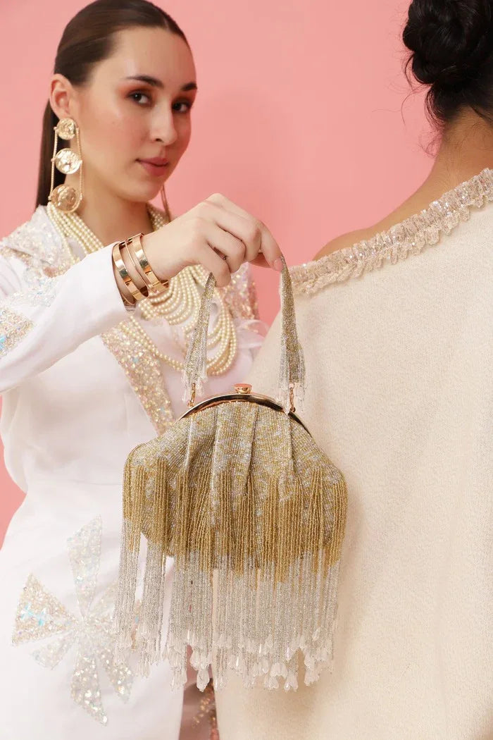 Tan Clan Amour Batua bag with detachable handle, featuring sleek design and structured shape in neutral tones.