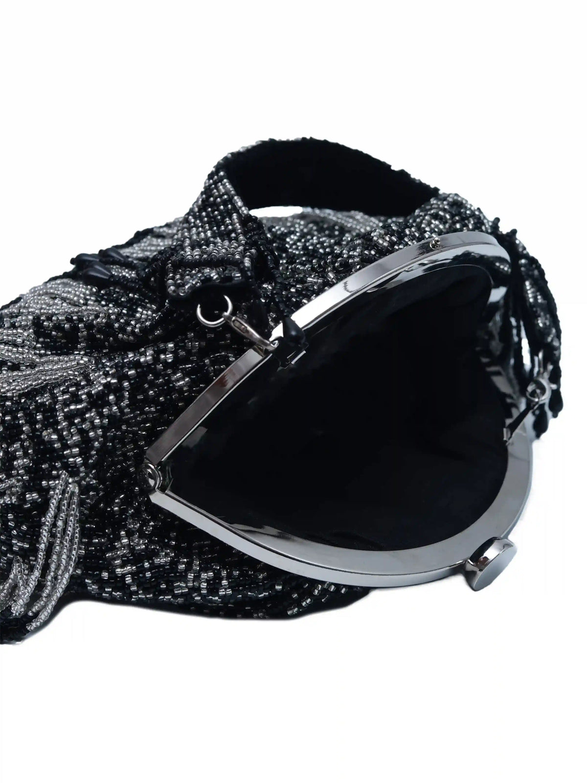 Black Batua bag with detachable handle by The Tan Clan, featuring sleek design and versatile styling options.