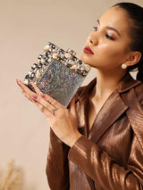 Brass clutch with intricate embellishments from The Tan Clan, featuring detailed decorative patterns and a sleek design.