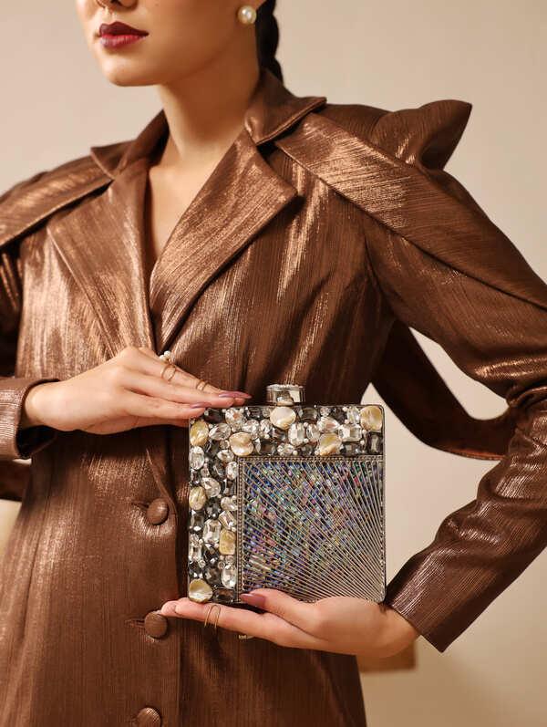 Aqua embellished brass clutch bag with intricate design, featuring detailed craftsmanship and a sleek, elegant appearance.