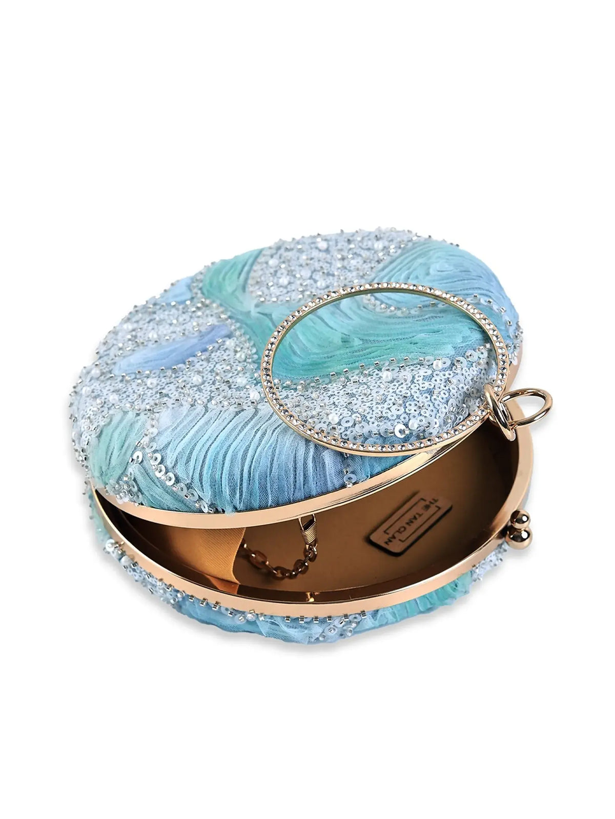 Aqua blue round clutch bag by The Tan Clan with a smooth surface and compact design, perfect for evening accessories.