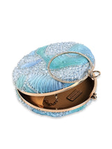 Aqua blue round clutch bag by The Tan Clan with a smooth surface and compact design, perfect for evening accessories.