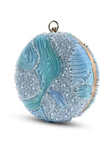 Aqua blue round clutch bag from The Tan Clan with a sleek, smooth finish and minimal design, perfect for evening accessories.