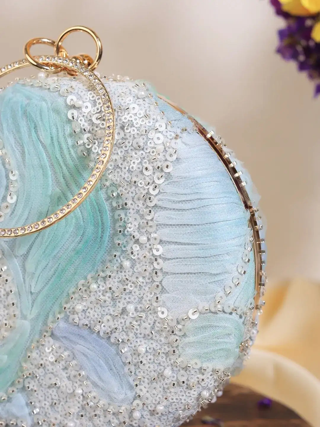 Aqua blue round clutch purse by The Tan Clan with a sleek, minimalist design and smooth finish.