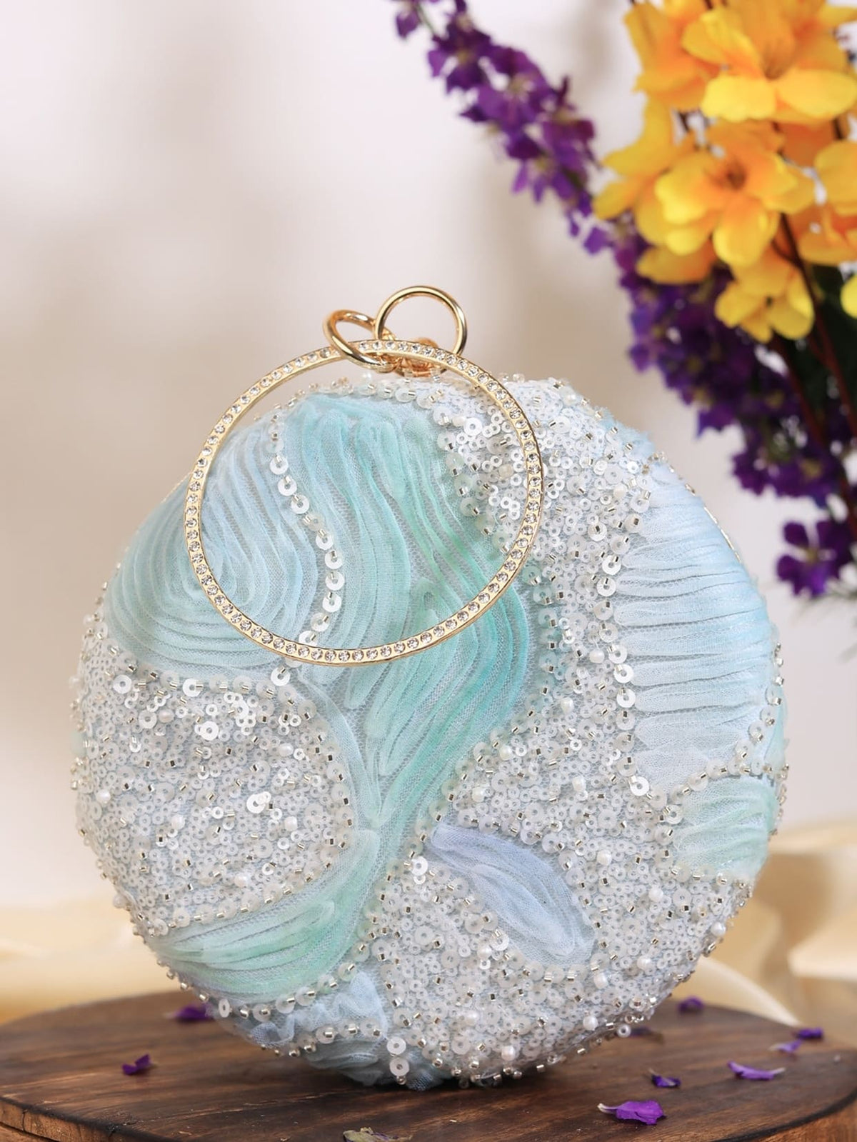 Aqua blue round clutch bag by The Tan Clan with a sleek, smooth surface and compact design for stylish essentials.