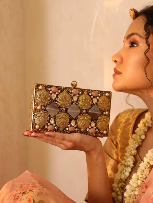 Arya embellished brass clutch with intricate design and decorative accents, crafted by The Tan Clan.