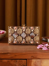 Elegant brass clutch with intricate embellishments, featuring a stylish design by The Tan Clan.
