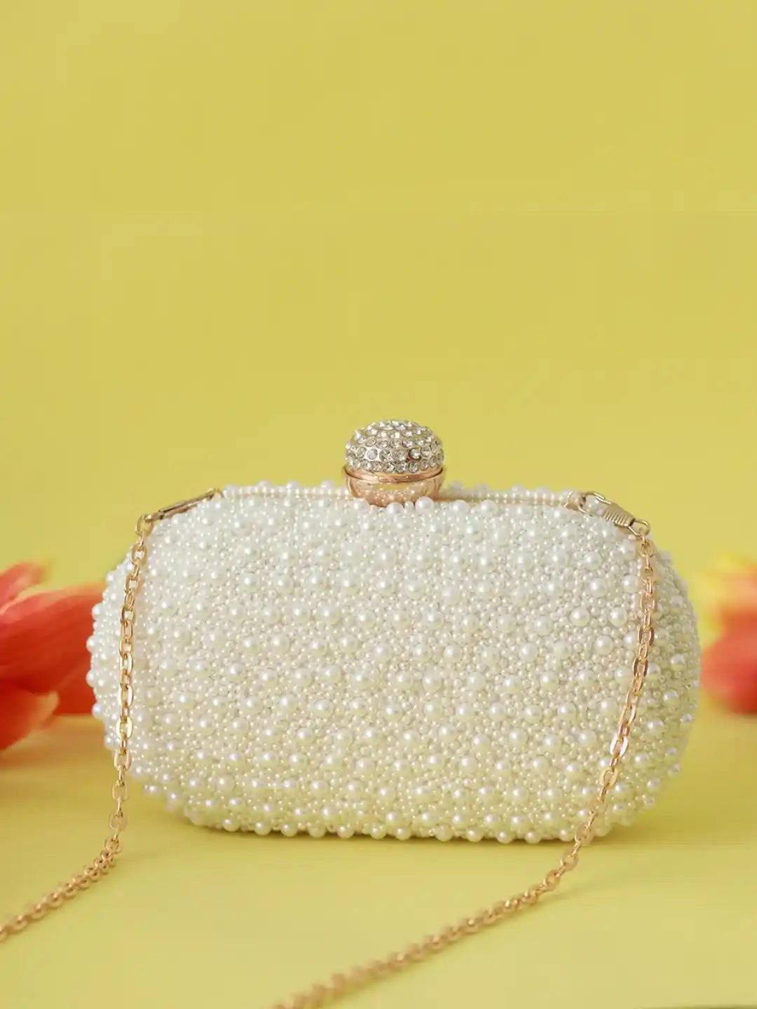 White pearl hand-embroidered clutch bag with intricate detailing, designed by The Tan Clan.