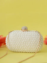 White pearl hand-embroidered clutch bag with intricate detailing, designed by The Tan Clan.