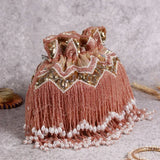 Asmi Potli bag by The Tan Clan featuring tassels and a handle, with traditional design and intricate detailing.