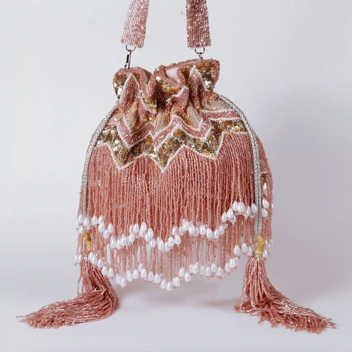 Asmi Potli bag with tassels and handle from The Tan Clan, featuring decorative tassels and a stylish design.
