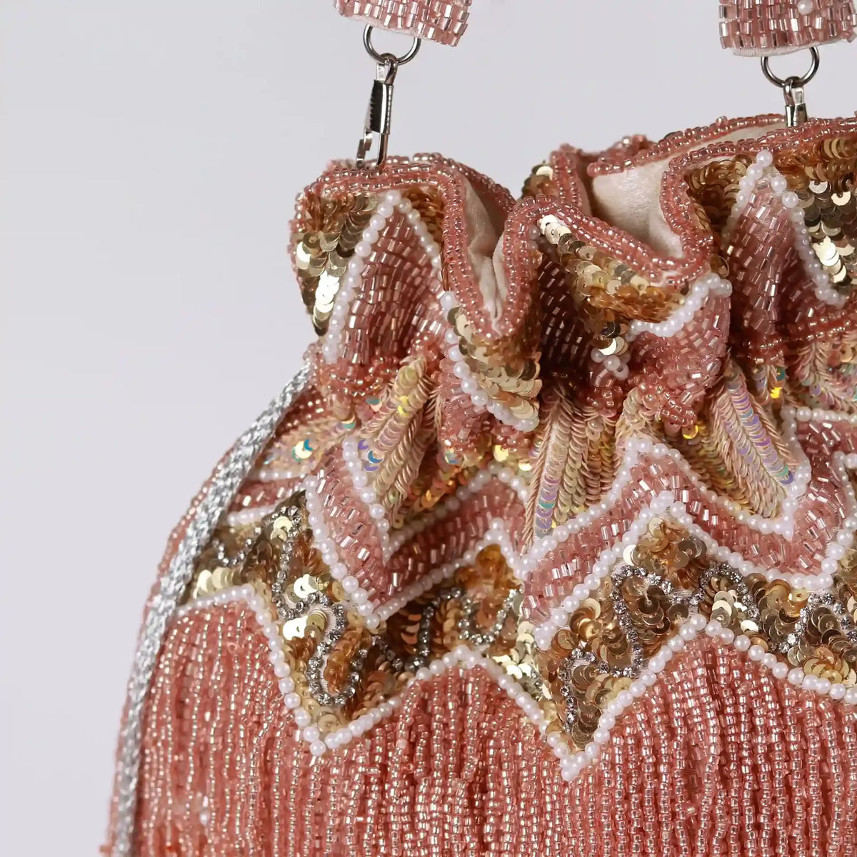 Asmi Potli bag with tassels and handle by The Tan Clan, featuring traditional embroidery and decorative design.
