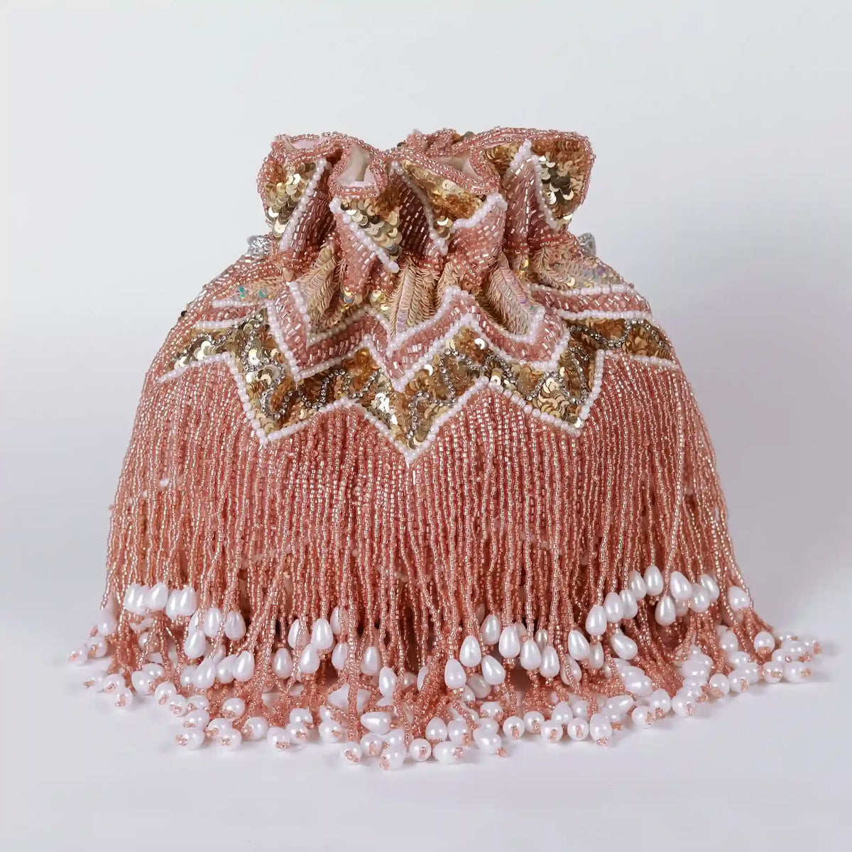 Asmi potli bag with tassles and handle by The Tan Clan, featuring traditional design and decorative accents.