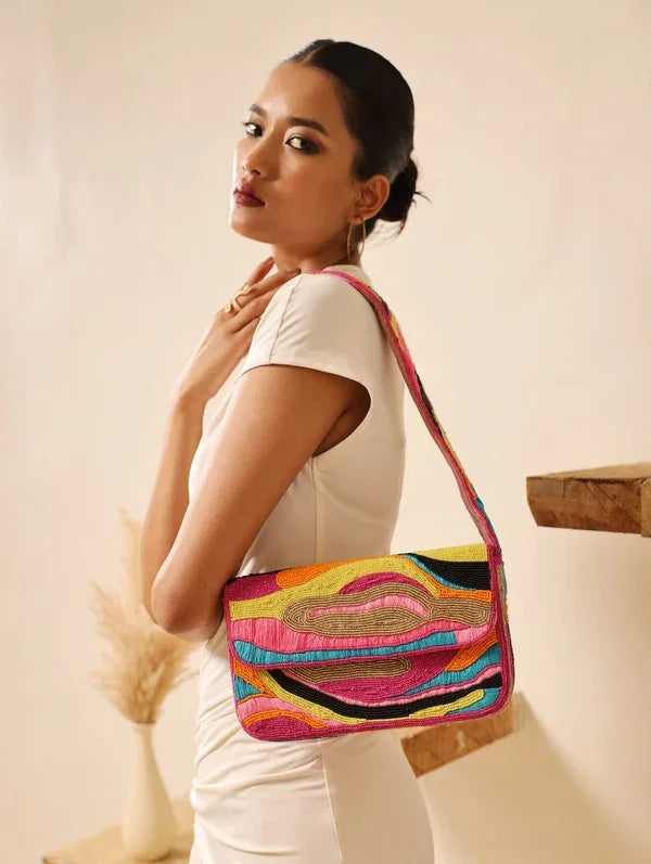 Multicolor Aster Baguette Bag with handle by The Tan Clan, featuring vibrant woven design and compact, stylish shape.