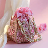 Hand embroidered mini lotus potli bag by The Tan Clan, featuring intricate embroidery and traditional design.