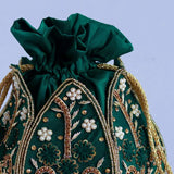 Hand-embroidered mini lotus potli bag by The Tan Clan featuring intricate embroidery and a traditional design.