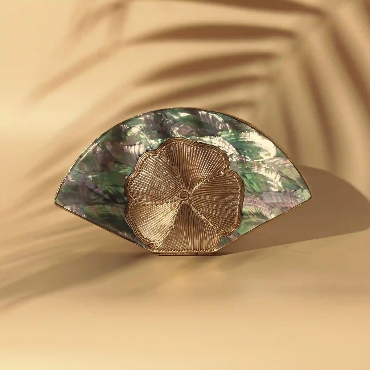 Bahaar brass wirework clutch with mother of pearl accents by The Tan Clan, showcasing intricate craftsmanship and elegant design.