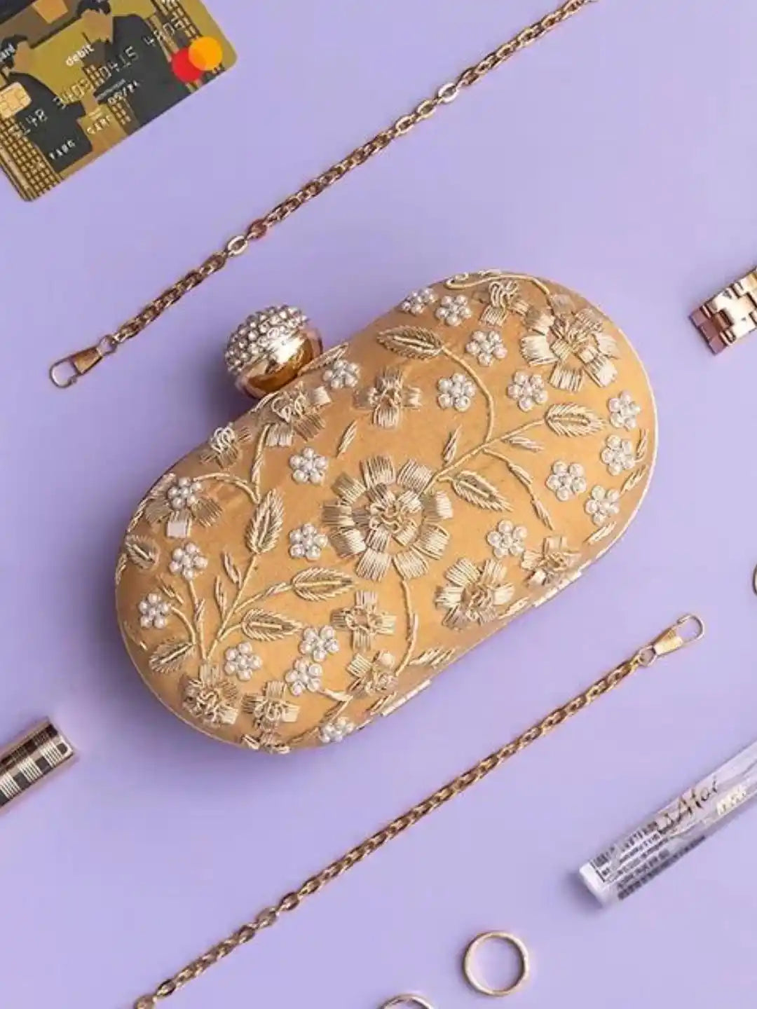 Hand-embroidered Baiza Zardozi clutch by The Tan Clan with intricate zari work and traditional design.