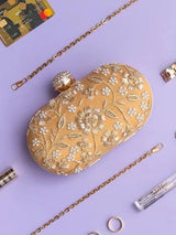 Hand-embroidered Baiza Zardozi clutch by The Tan Clan with intricate zari work and traditional design.