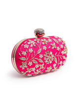Elegant Baiza Zardozi hand-embroidered clutch by The Tan Clan with intricate gold and colorful embroidery on a velvet surface.