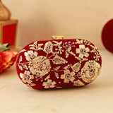 Elegant Begum Zardozi hand-embroidered clutch by The Tan Clan with intricate gold and colorful threadwork on a traditional purse.