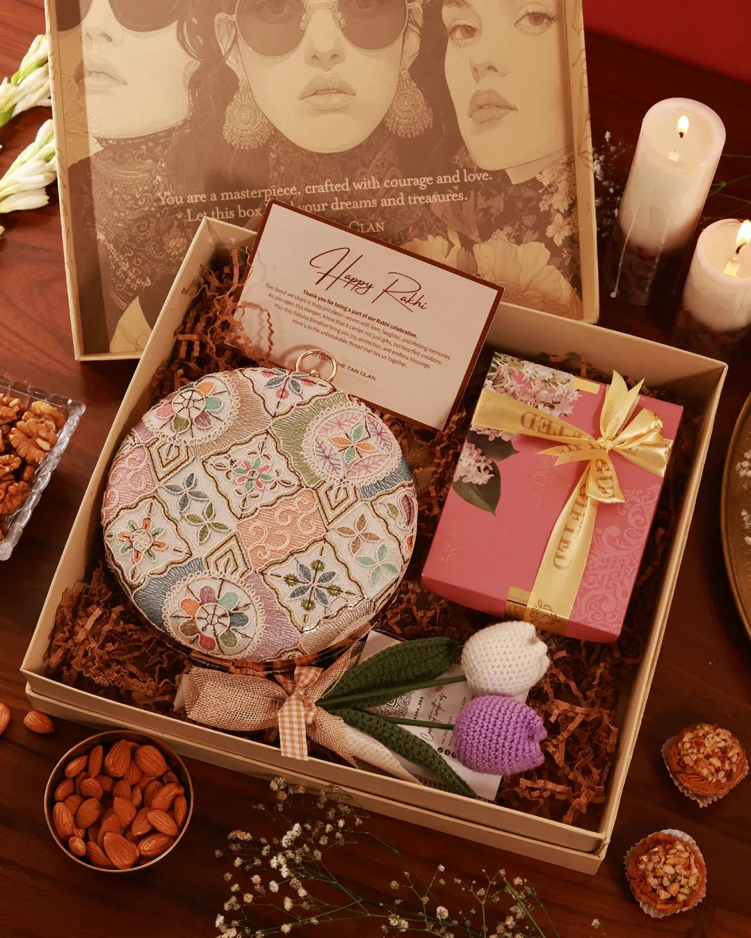 A luxurious gift hamper from The Tan Clan featuring an assortment of skincare products and wellness items arranged attractively.