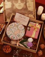 A luxurious gift hamper from The Tan Clan featuring an assortment of skincare products and wellness items arranged attractively.