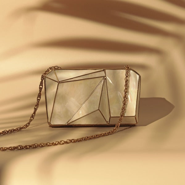 Bushra 3D Mother of Pearl clutch by The Tan Clan, showcasing a shimmering, intricate pearl design on a sleek, elegant evening bag.