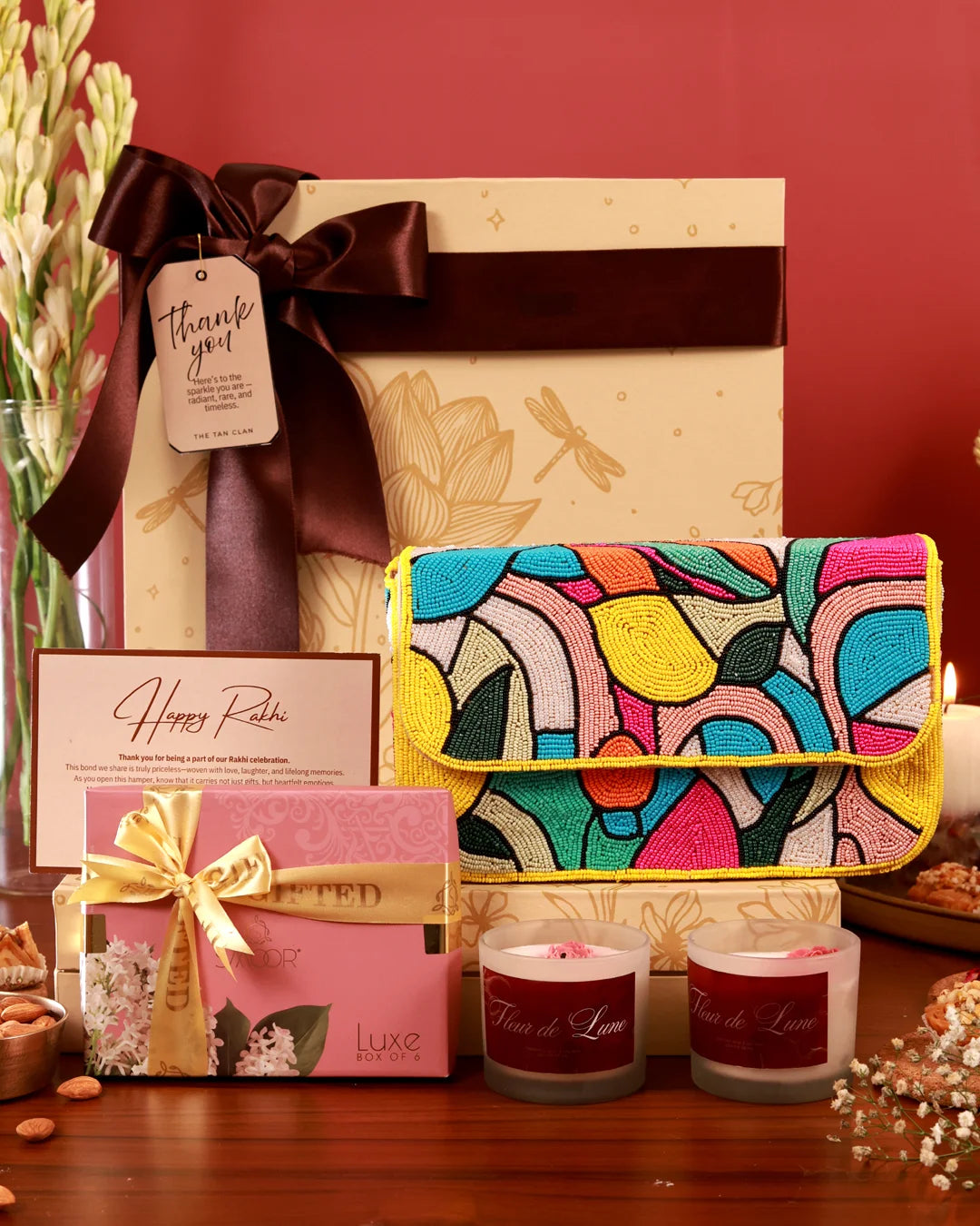 Celebrate Her Hamper by The Tan Clan featuring a floral arrangement, gift box, and luxurious packaging for special occasions.