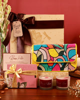 Celebrate Her Hamper by The Tan Clan featuring a floral arrangement, gift box, and luxurious packaging for special occasions.