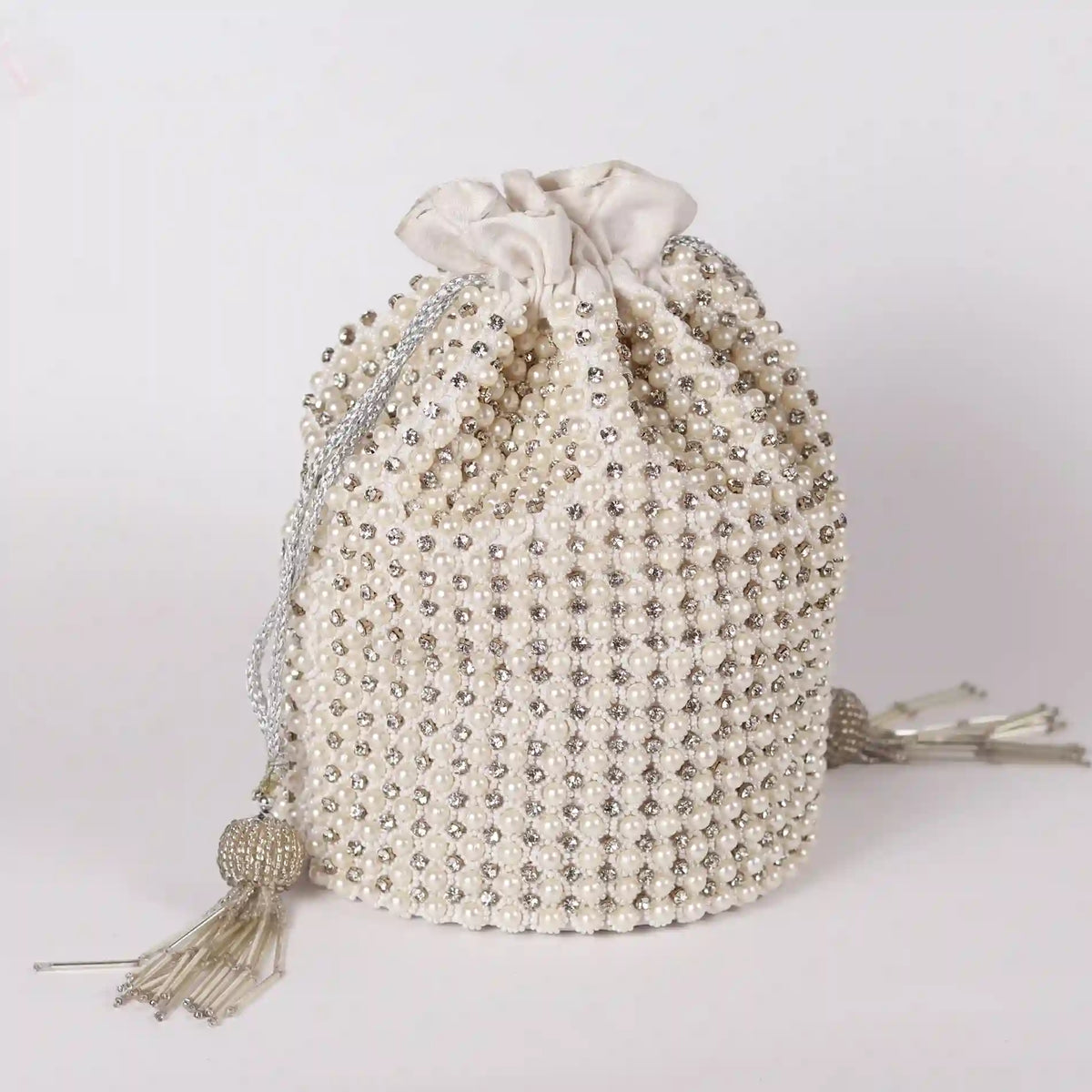 Chhaya Potli bag with embroidered handle by The Tan Clan, featuring intricate embroidery and traditional design.