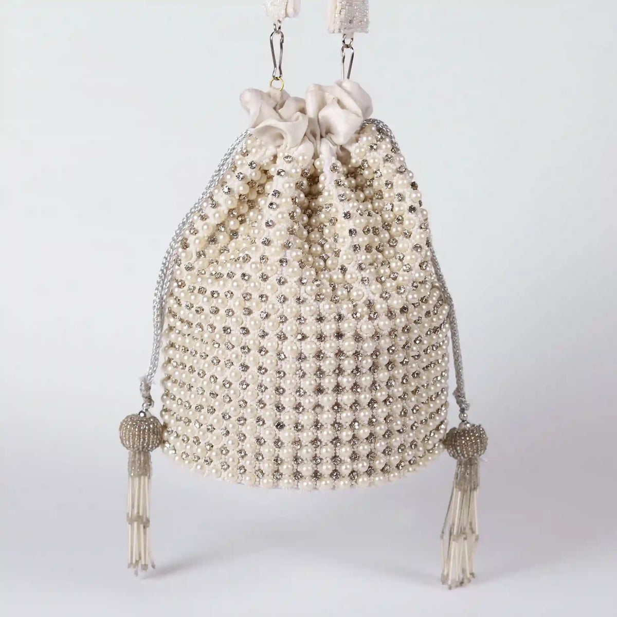 Chhaya Potli bag by The Tan Clan with embroidered handle, featuring intricate embroidery and traditional design.