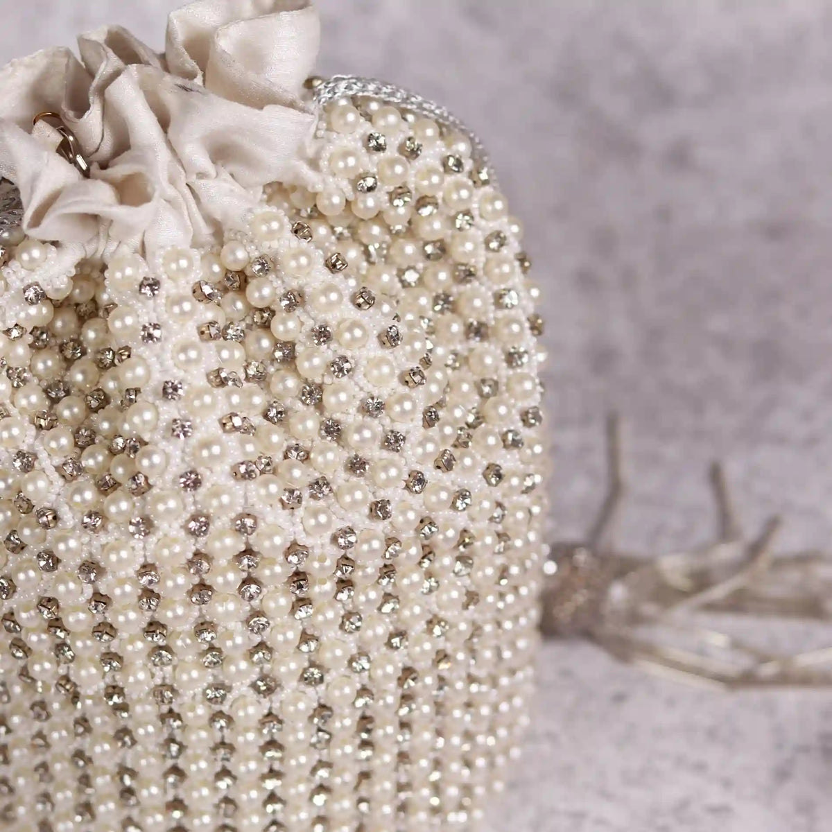 Chhaya Potli bag by The Tan Clan with embroidered handle, showcasing intricate embroidery and traditional design.