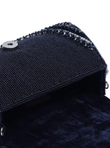 Chloe black flap-over bag with handle and gold hardware, featuring a sleek design and structured silhouette.