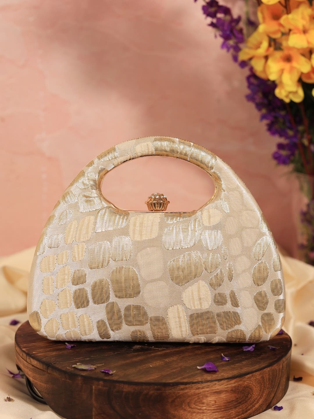 Beige Coral Arc clutch bag by The Tan Clan with a sleek, curved design and elegant texture, perfect for stylish occasions.