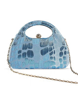 Coral Arc Blue Clutch by The Tan Clan featuring a sleek, curved design and vibrant coral-blue color, perfect for stylish occasions.