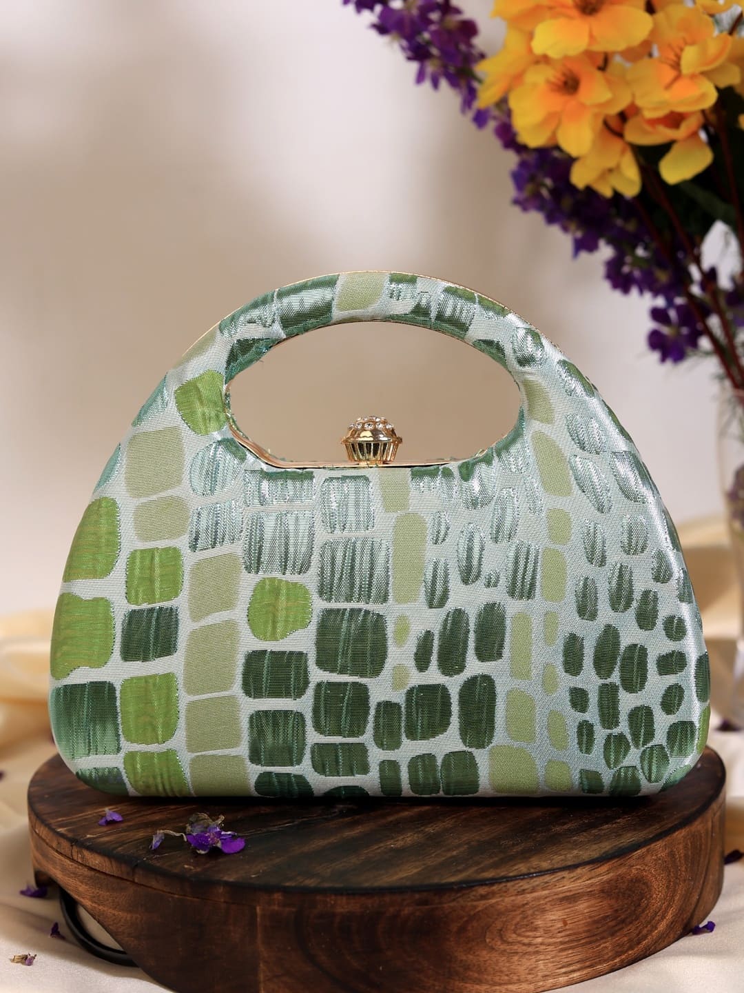 Coral Arc Green Clutch by The Tan Clan with curved design and gold clasp, showcasing a stylish accessory for evening or casual wear.