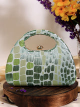 Coral Arc Green Clutch by The Tan Clan with curved design and gold clasp, showcasing a stylish accessory for evening or casual wear.
