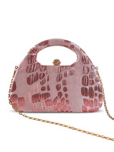 Pink Coral Arc clutch bag by The Tan Clan featuring a sleek, curved design and compact size for stylish accessorizing.