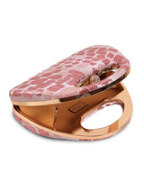 Coral Arc Pink clutch purse by The Tan Clan featuring a sleek, curved design and vibrant pink color.