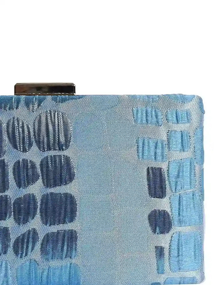 Coral Sleek Blue Clutch by The Tan Clan, featuring a stylish compact design with a smooth finish and elegant closure.
